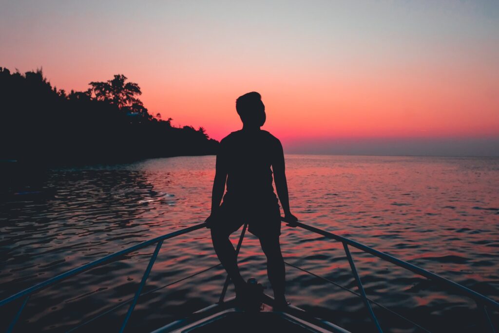 BAM! Be A Man. Man Alone On A Boat. Sunset.